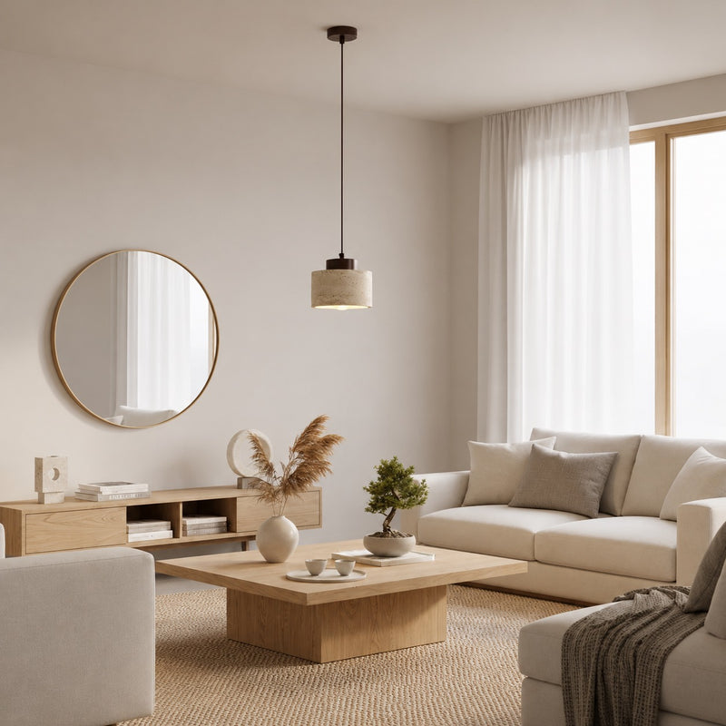 Travertine Stone Pendant hanging in a bright living room with a sofa and round mirror