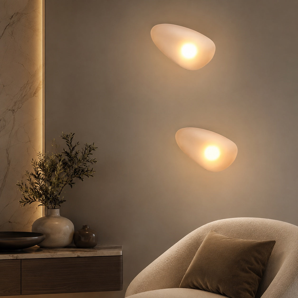 Pebble-inspired glass wall sconce with warm 3000K light for living room