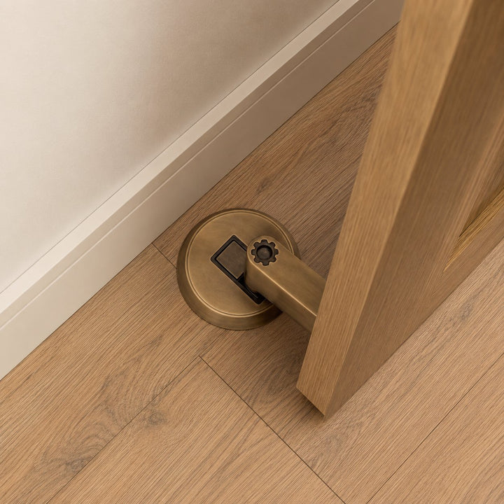 Modern Brass Door Stop with Cylindrical Design and Soft-Touch Mechanism for Floor Protection