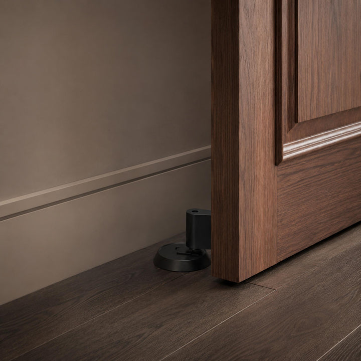 Modern Brass Door Stop with Cylindrical Design and Soft-Touch Mechanism for Floor Protection
