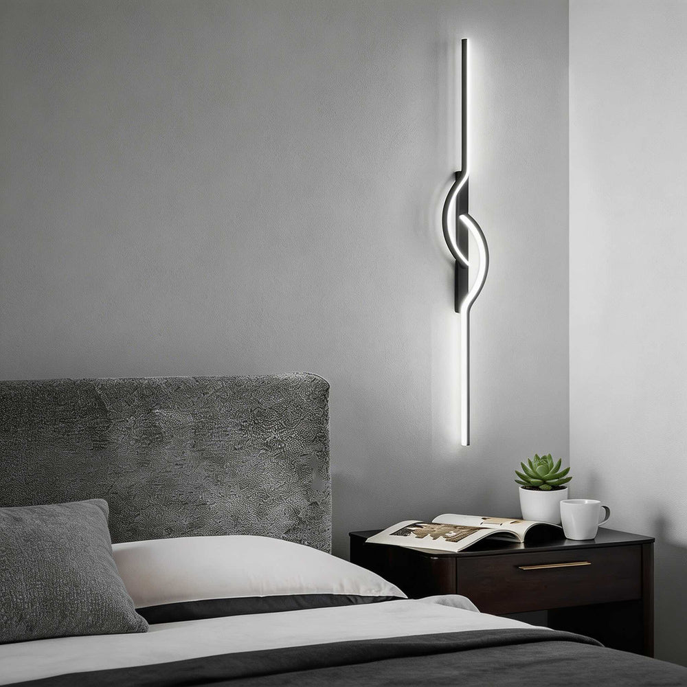 Tall black vertical LED wall sconce with centre loop detail and cool white glow, modern bedside wall light Australia