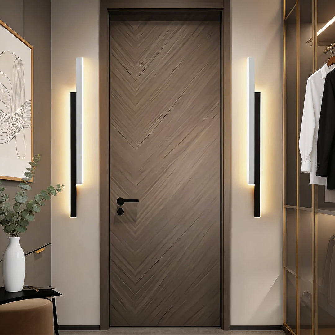 Wall lights in black and white finish with slim linear LED silhouette, modern vertical sconces with soft ambient glow and clean design