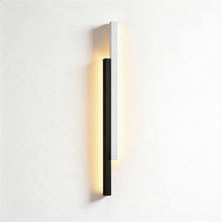 Wall lights in black and white finish with slim linear LED form, modern vertical sconce design with warm backlit glow and clean lines