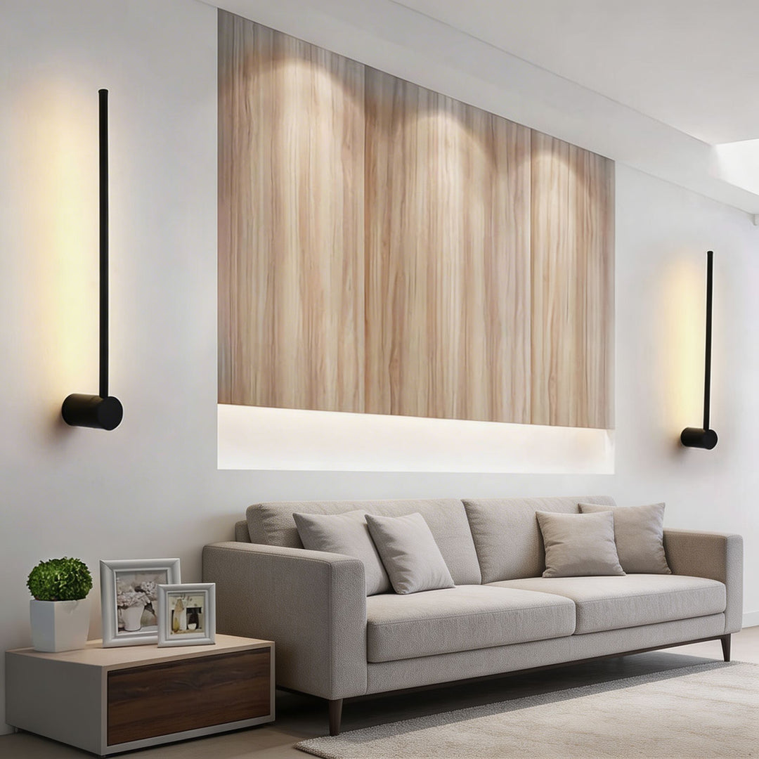 Wall lights in matte black with slim vertical rod and round mount, minimalist LED sconces with warm glow and sleek modern silhouette