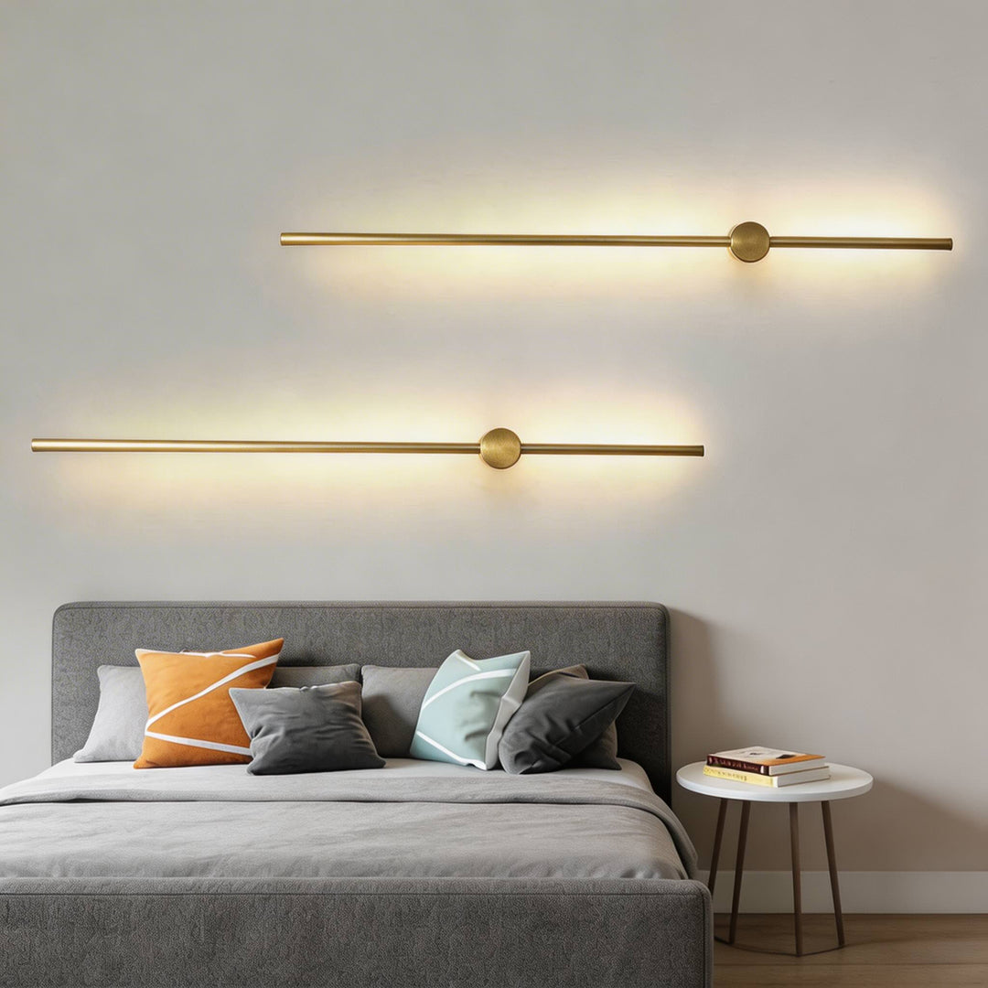Wall lights in brushed gold with slim linear LED design, modern bar sconces with round centre detail and soft ambient glow