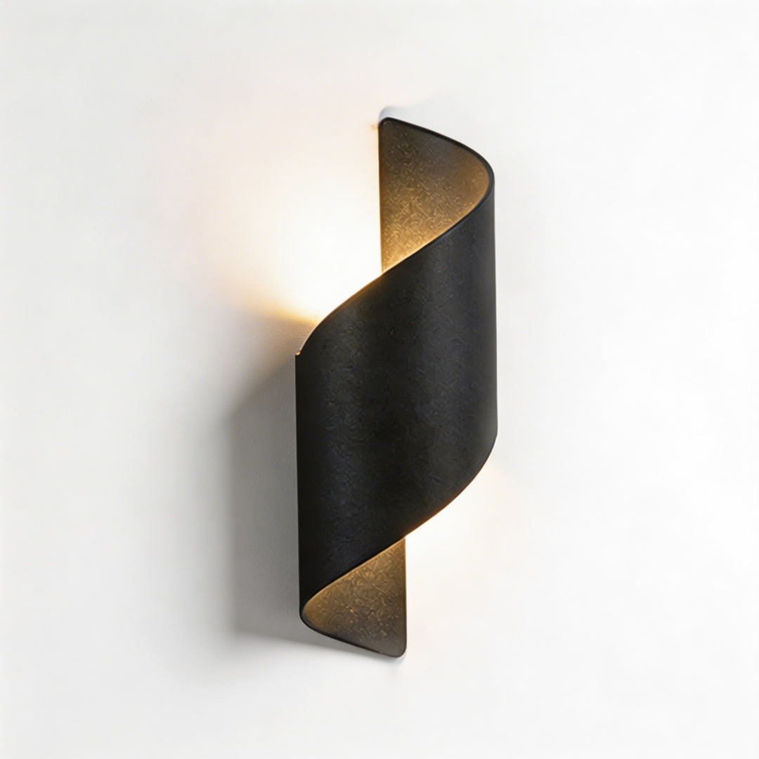 Wall sconce in black twisted design, modern wall light with warm up and down illumination and bold sculptural silhouette