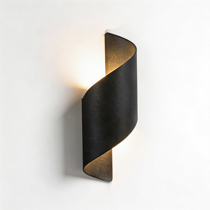 Wall sconce in black twisted design, modern wall light with warm up and down illumination and bold sculptural silhouette