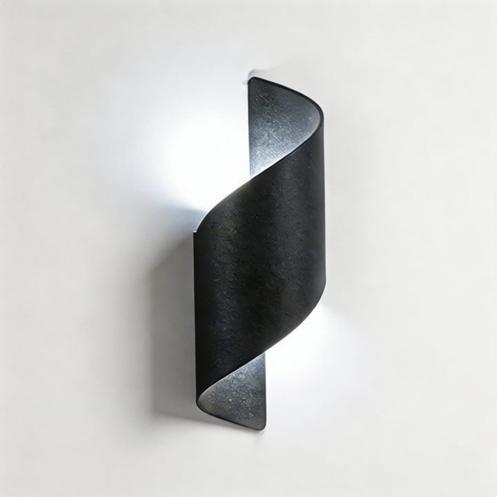 Wall sconce in black twisted design, modern wall light with soft up and down illumination and sleek sculptural silhouette