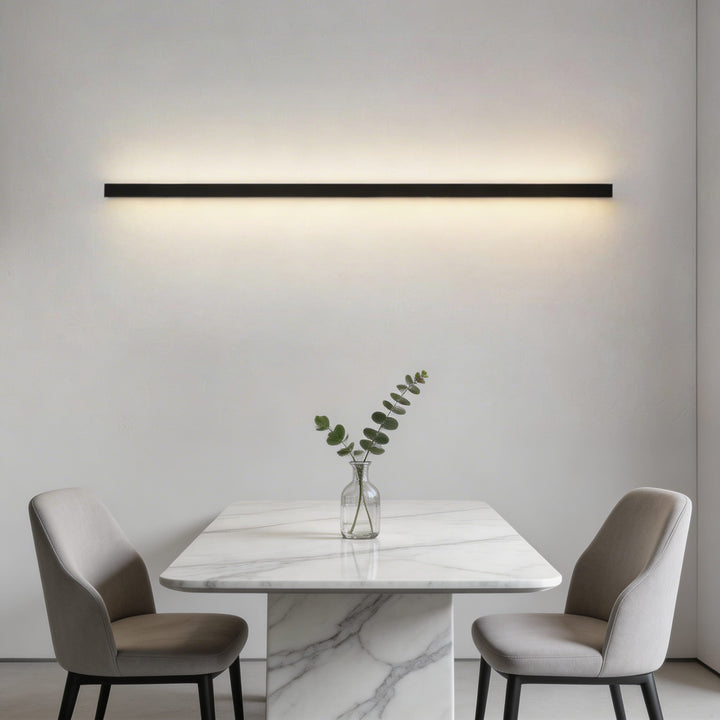 Slim black linear LED wall sconce above marble dining table, long bar wall light for dining room Australia