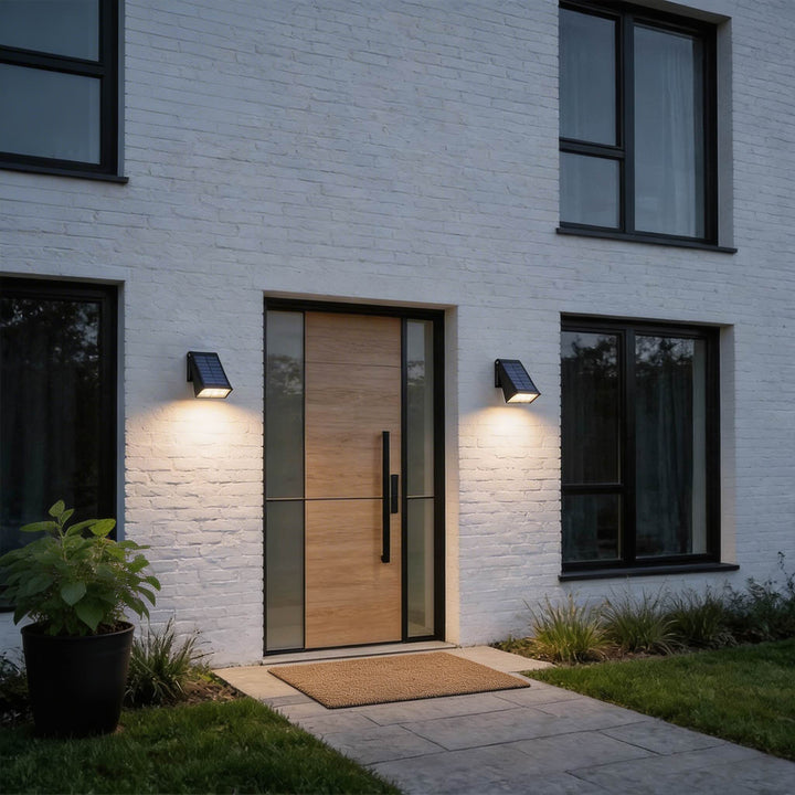 Wall lights black solar LED sconces with angled rectangular housing, integrated top panel and soft downward illumination for modern facades lighting