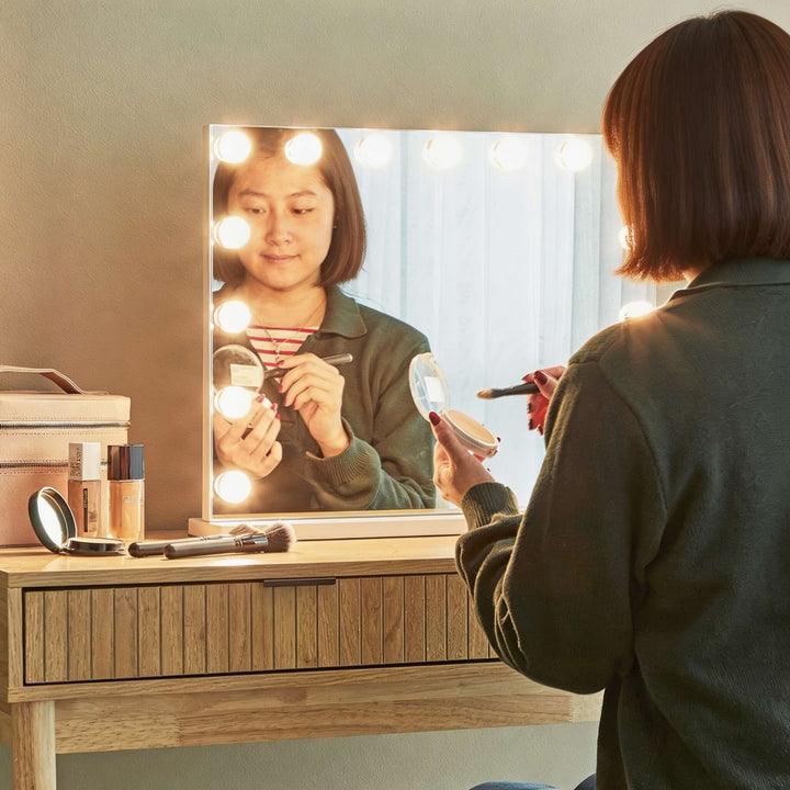 Hollywood vanity mirror with LED globe bulbs on dressing table


