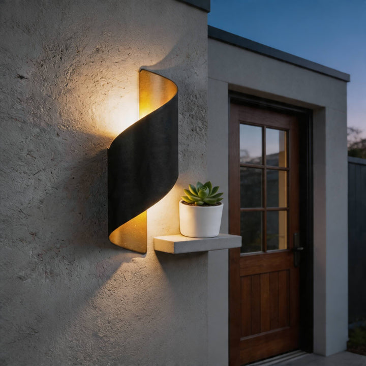 Wall light in black twisted design, modern outdoor sconce with warm up and down illumination and bold sculptural silhouette